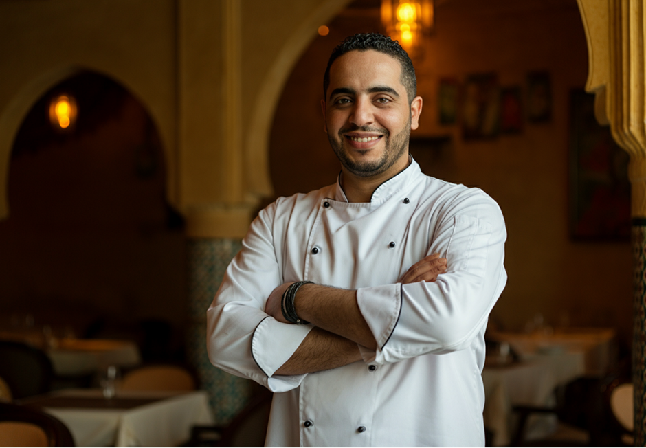 Chef in a cuisine in his restaurant smiling to the camera, moroccan men